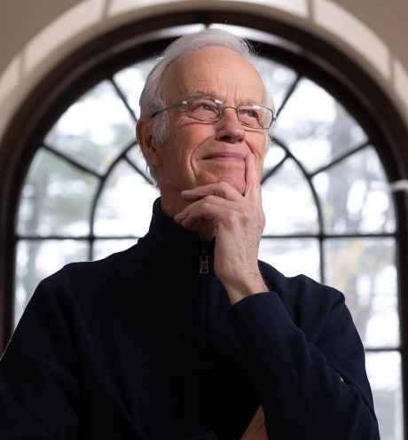 Participant Robert - person with short white hair and glasses in front of a window