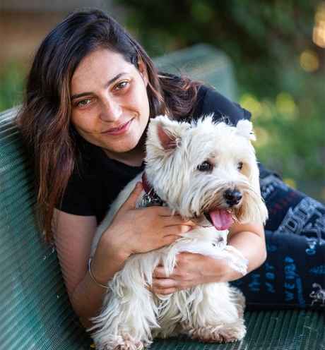 Participant Shelly - person with long dark hair with a small white dog