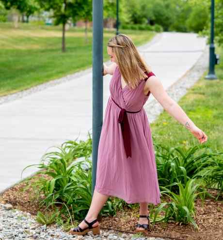 Participant Winter - person with long blond hair wearing a pink dress walking outside