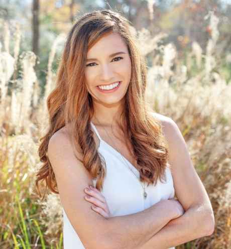 Participant Cali - person with long wavy hair smiling