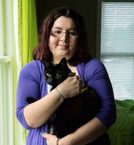 Participant Christina - person with shoulder length dark hair and glasses wearing a purple sweater
