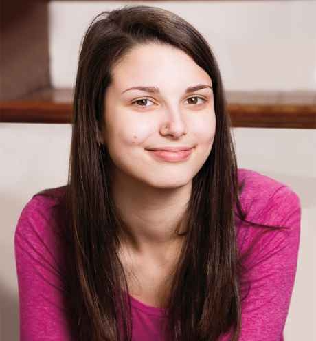 Deconstructing Stigma participant Mary - person with long brown hair in pink shirt