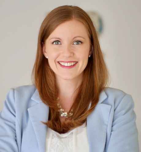 Deconstructing Stigma participant Andrea - long red hair and pale blue blazer
