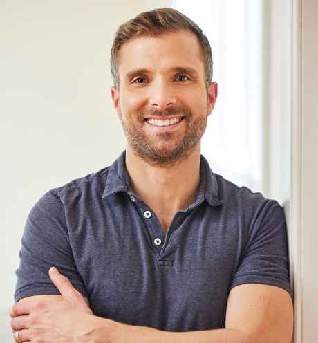 Deconstructing Stigma participant Liam - person in polo poses with arms crossed