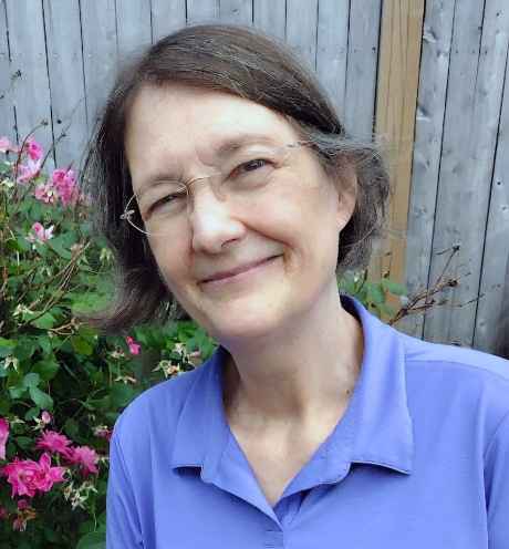 Deconstructing Stigma participant Lisa - person with short hair and glasses stands in garden