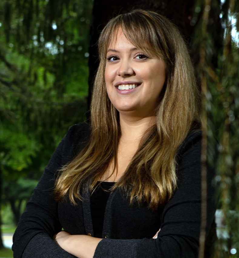 Participant Kimberly - person in a sweater among trees