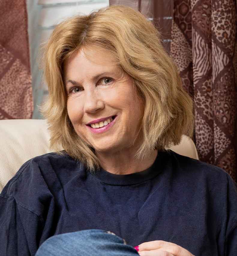 Participant Lisa - person with short blond hair sitting in a chair