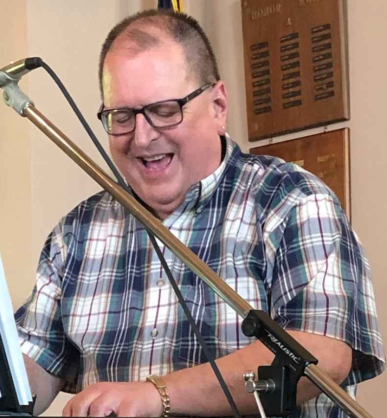 Participant Thomas - person smiling playing a keyboard