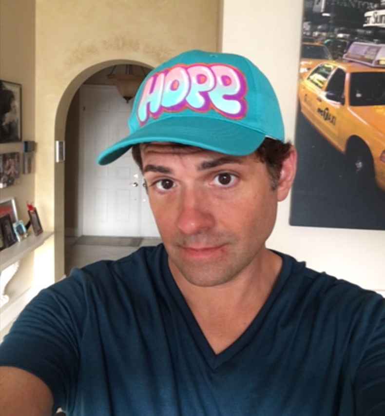Participant David wearing a hat that says Hope