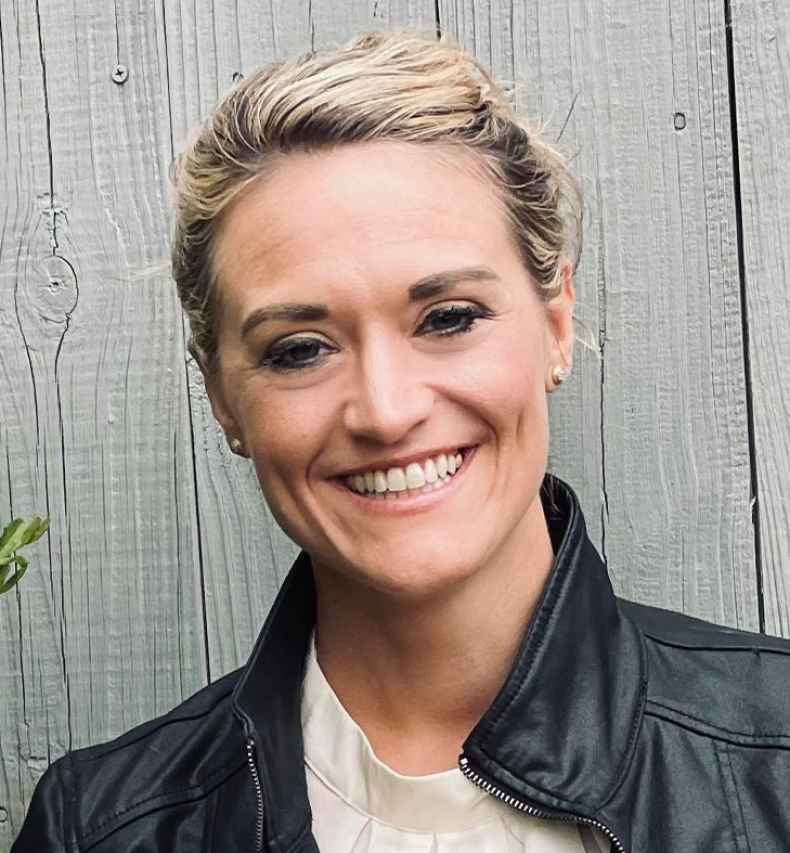 Participant Mandy - person with blond hair pulled back into an updo wearing a black leather jacket