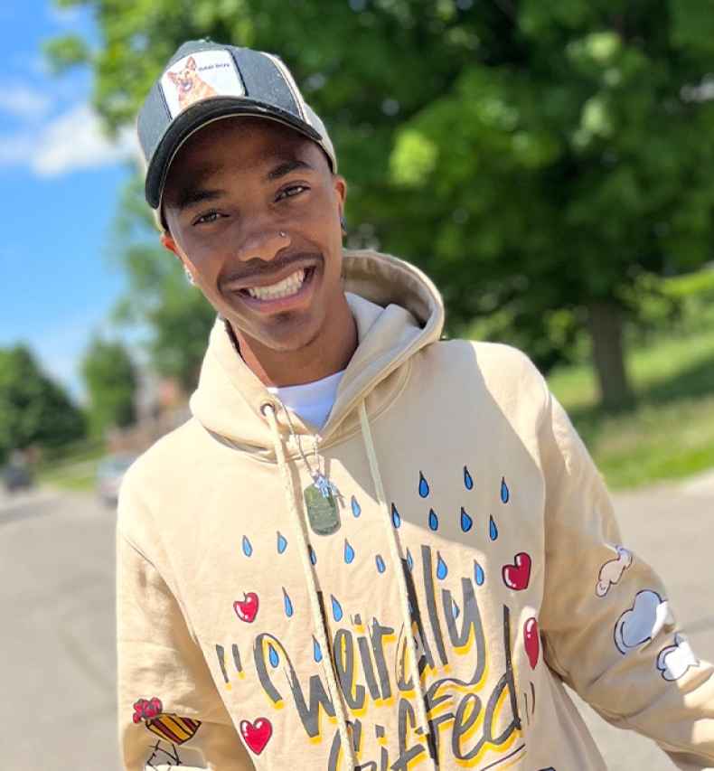Participant Marquez - person wearing a yellow sweatshirt and a baseball hat
