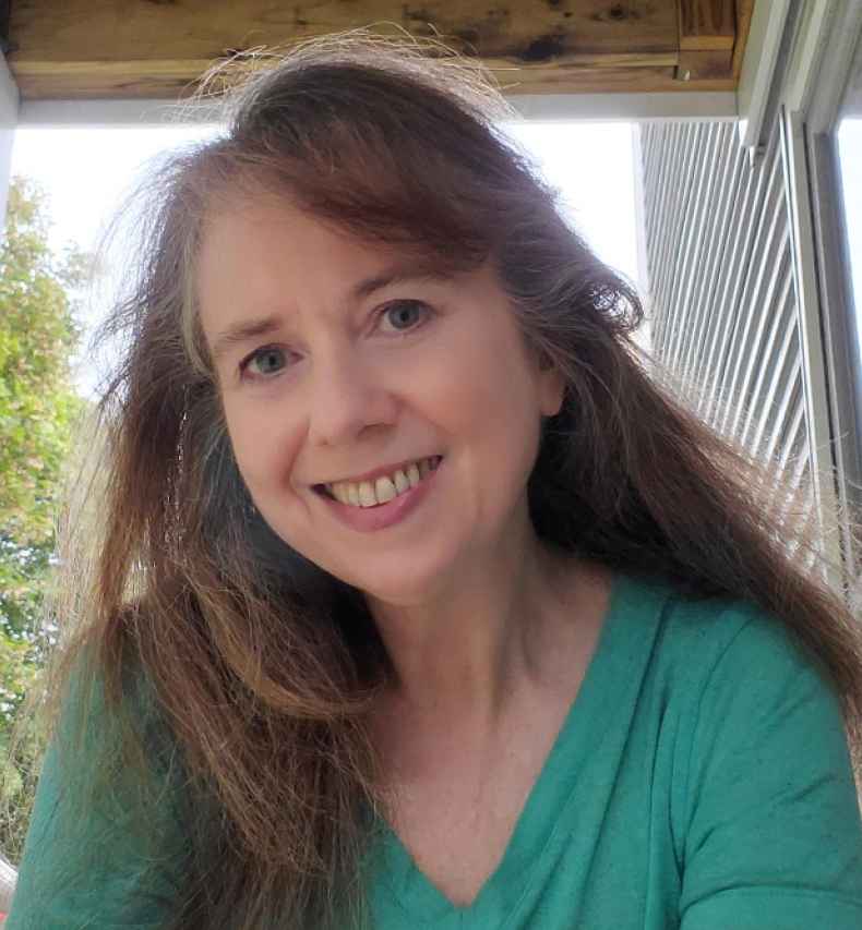 Participant Phyllis - person with long light brown hair smiling outside