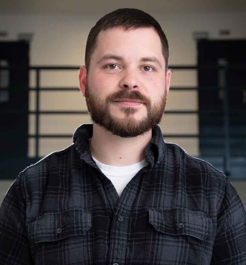 Participant Ron - person in plaid shirt in front of doors