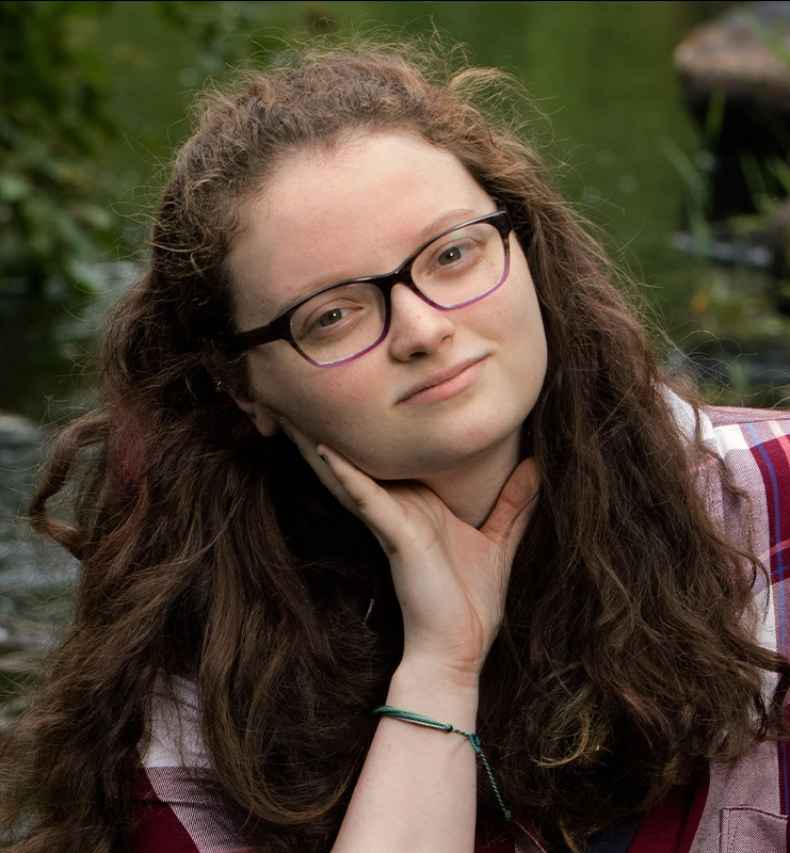 Participant Molly - person with brown wavy hair and glasses outside