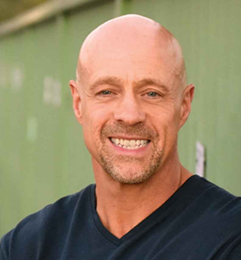 Participant David - person with facial hair smiling in front of a light green wall