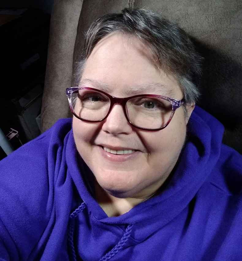 Participant Shirley smiling wearing glasses