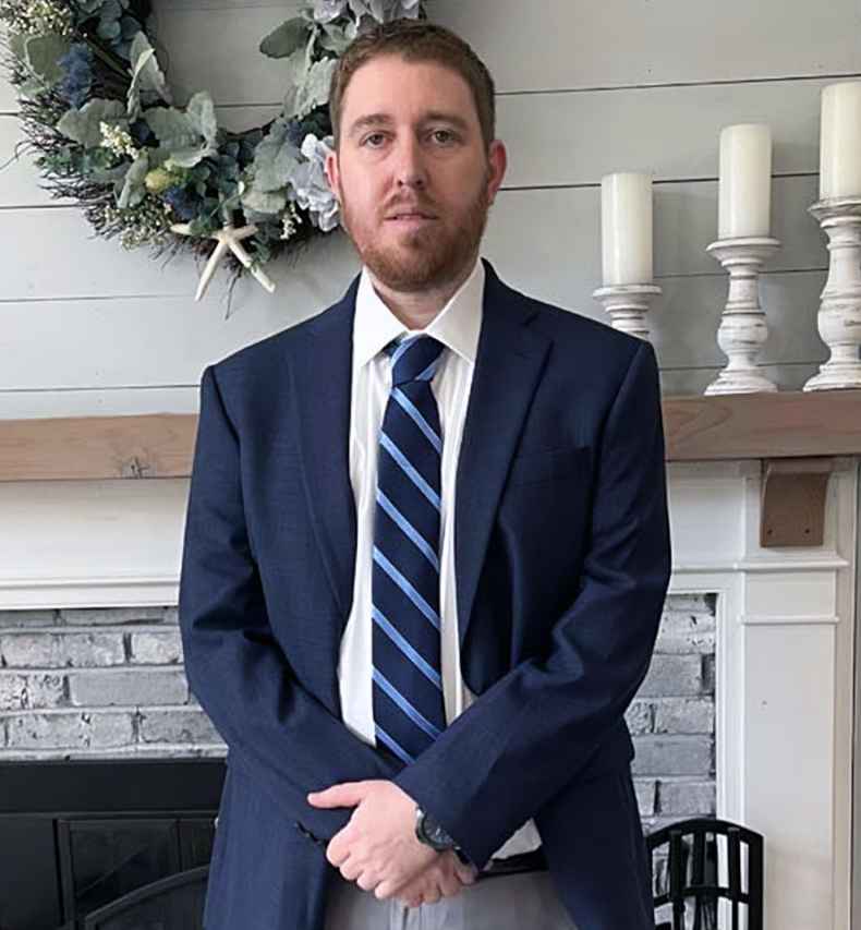 Participant Mike wearing a dark blue suit and tie