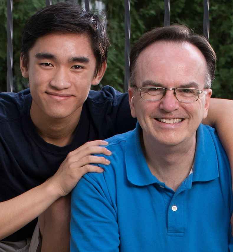 Participant Paul and participant Joel - two people wearing blue shirts sitting and smiling