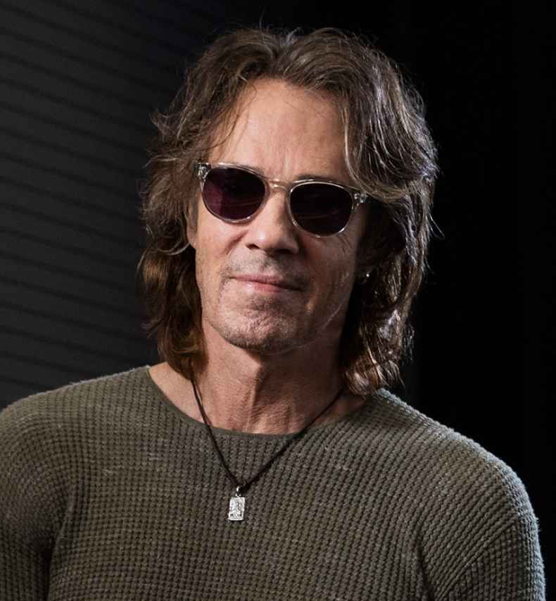 Deconstructing Stigma participant Rick - person in sunglasses in dark room