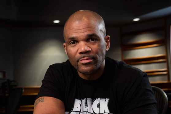 Participant Darryl - person wearing a black t-shirt in a grey room