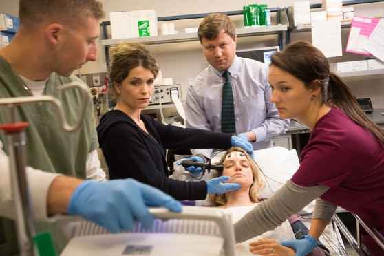 Clinicians deliver ECT to a patient