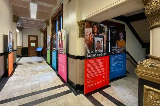 Narrative panels on display in ornate city building hallways