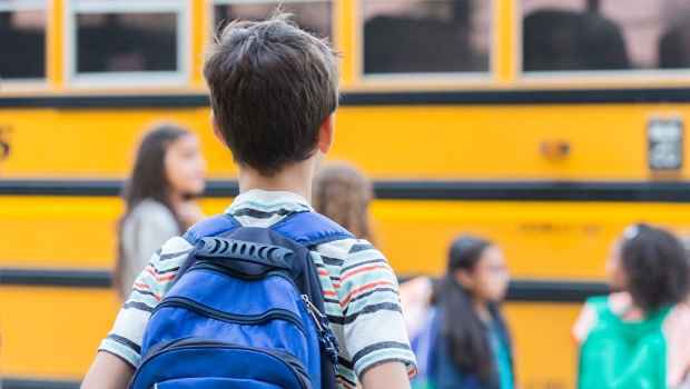 Kids in line for school bus