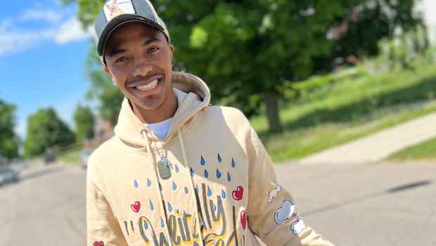Participant Marquez - person wearing a yellow sweatshirt and a baseball hat