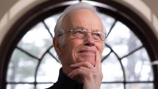 Participant Robert - person with short white hair and glasses in front of a window