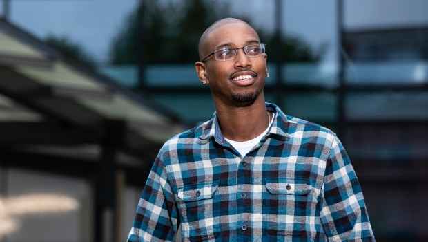 Participant Charles - person with very short hair and glasses walking outside