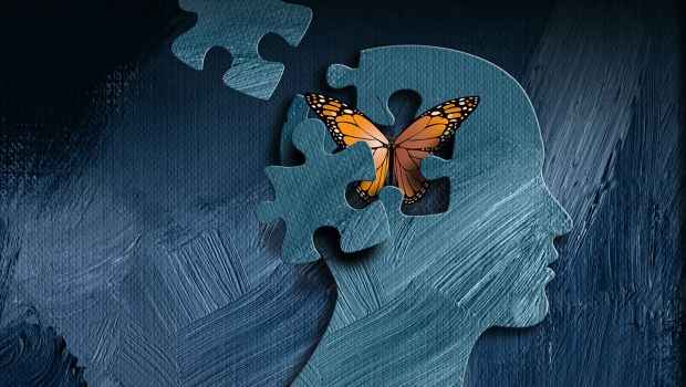 Graphic of a head with a puzzle piece missing and a butterfly flying out