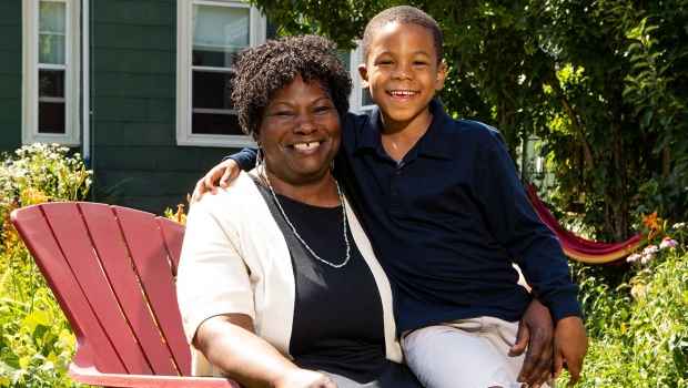 Participant Cynthia - an adult and a child sit outside with greenery behind them