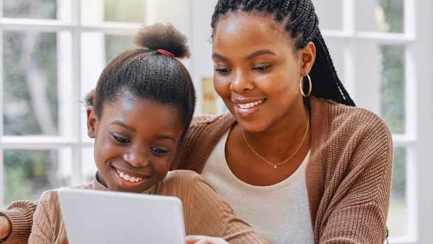 Mom and kid look at tablet together