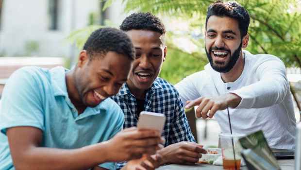 Men hanging out together at outside table