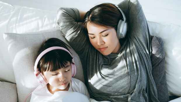 Mom and daughter listening to headphones