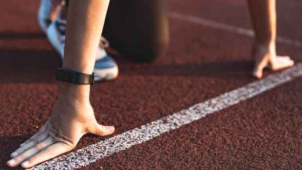 Close-up shot of someone’s hands at the starting position of a track race