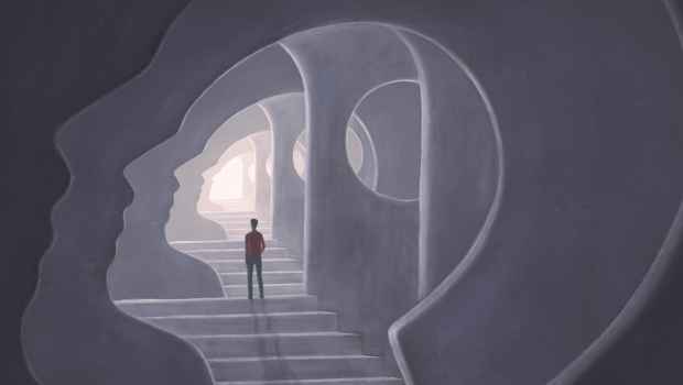 Illustration of a man standing in a cave that is the shape of a face profile