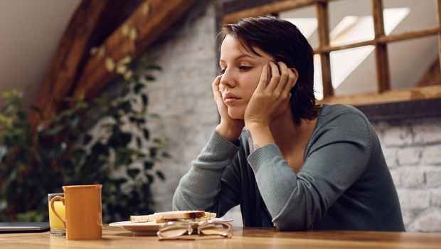 woman at a table looking sad