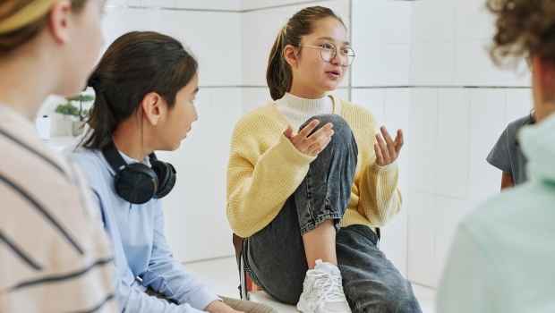 Young people chat in group therapy