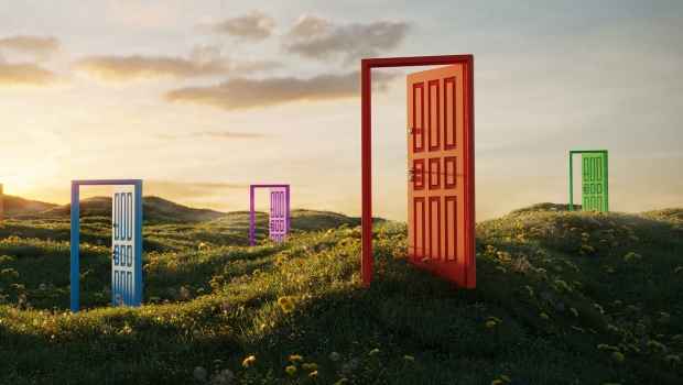 Colorful open doorways scattered in a meadow