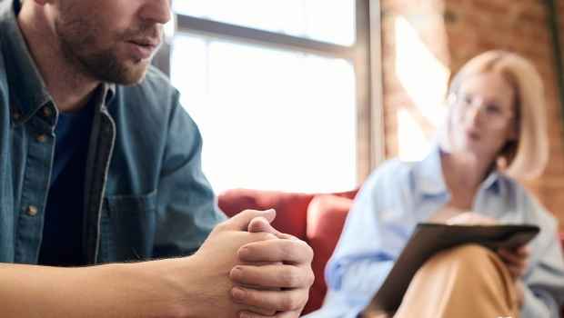 Man sits in therapy session
