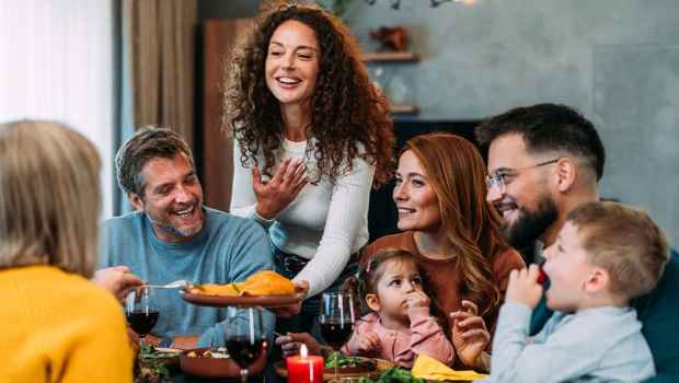 Group of people smiling around a table with food
