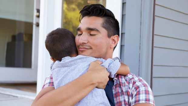 Man hugging son and smiling