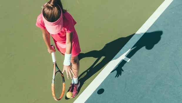 Aerial view of a girl bouncing a tennis ball