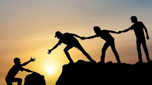 Illustration of figures helping another figure climb