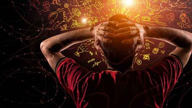 Figure facing away with hands on head and swirling icons above
