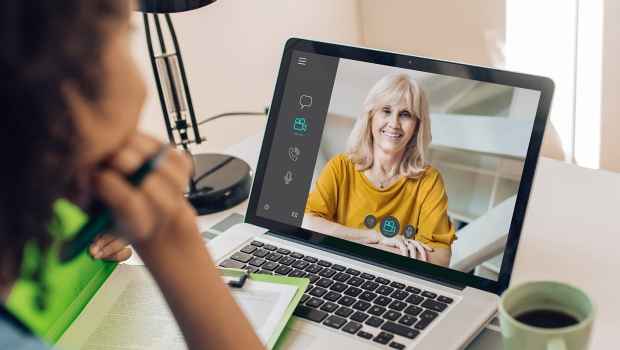 Person watching person on laptop screen
