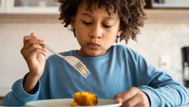 Kid with fork eating