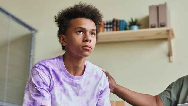 Youth looks out with adult