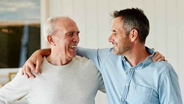 Man and older man with arms around shoulders
